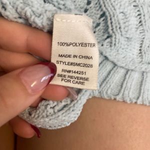 Blue sweater crop top with a knitted with a knotted back